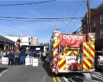 A Dover, NJ fire engine is part of the Toys for Tots festivities in Downtown Dover as the train sits in the background 